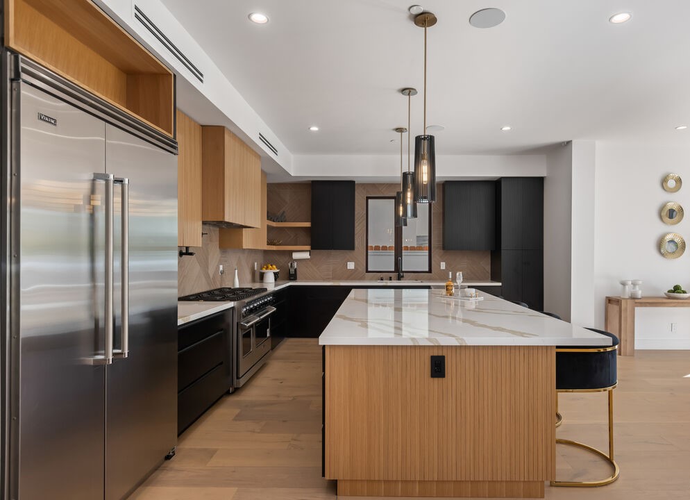 Sophisticated Kitchen Remodel with Waterfall Island and Herringbone Backsplash 2